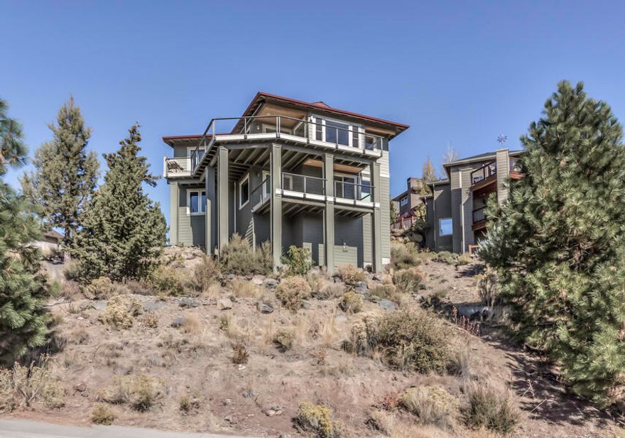 A one of a kind custom home in Bend's Golden Butte neighborhood with views that will knock your socks off. No detail was overlooked in the design and build of this Earth Advantage Platinum Home. Enjoy the luxurious appointments, huge vaulted ceilings and unobstructed views for miles. Construction highlights include: double wall construction, triple pane windows, heat ventilation recovery system, slab granite counters, hot water circulation pump. whole house sound system, and 12 solar panels.  
This thoughtful design allows for single level living with the primary suite, office, laundry, kitchen, and great room all on the main floor.  Downstairs provides the option of multi-generational living with a separate entrance,  kitchenette, two bedrooms with en suites and a 4th bedroom that could be a family/bonus room. Expansive, low maintenance decks wrap around the NW & SW sides of the home.  An oversized 2 car garage with epoxied floors, built in storage and a large utility sink