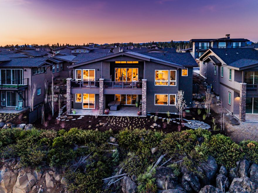 Beautiful, upgraded home situated on a premier view lot at The Rim at award-winning Tetherow Resort. This stunning home features many upgrades including an enlarged Primary Suite with a very spacious Walk-In Closet, Spa-like Bathroom, Fireplace and huge Cascade Mountain Views. The spacious floor plan is also enlarged in the laundry room area providing a more inviting space. Other upgrades include custom blinds throughout, double ovens, garage built-ins with a large work bench, extra closet systems, and acid stained concrete floor in the garage. The large, open floor plan features main level living including the enlarged master suite, another guest suite, office, laundry and open kitchen, living and dining room all overlooking the beautiful views, with an extra 2 guest suites downstairs, large 2nd living area and tons of storage! This home is truly turn key and ready to be enjoyed.