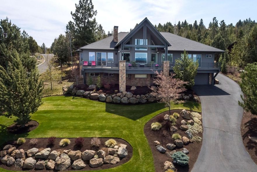 Perched atop Awbrey Butte this refreshing contemporary residence offers panoramic views of the Cascades & to the north & is an absolute entertainers delight! Auto enthusiasts will love the ability to easily park 4+ vehicles in the lower garage (with additional shop & storage space!) and 2 more vehicles in the upper garage. The main level encompasses a stunning, expansive great room with formal and informal dining areas, multiple living spaces set around a double sided custom fireplace, a bar area, kitchen, large office, laundry, luxurious main suite and a junior suite. Up a wide staircase adjacent to the entry is a large bonus room above the garage. Head downstairs to find another bedroom, bathroom, another large bonus room (could work as a bedroom) and the lower level entertainment area that includes a ping-pong room, a pool room with full wet bar and the elaborate theater room. The rear yard is fenced and has a private, covered patio with a built-in fireplace.