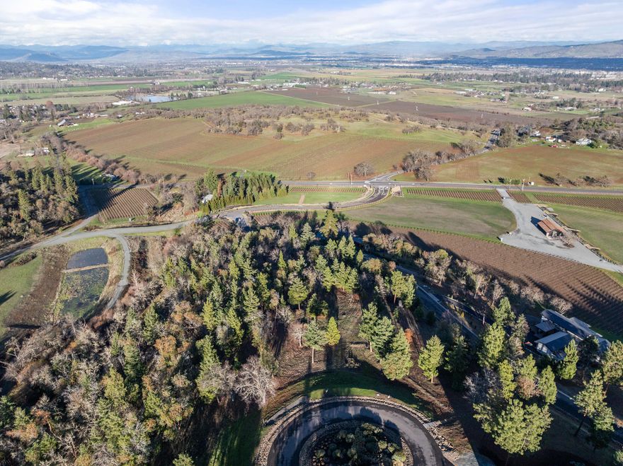 Build your dream home on this sprawling 3-acre parcel with panoramic views of the Rogue Valley! Mt McLoughlin, Upper Table Rock, Roxy Ann Peak, multiple vineyards, these never-ending views from the Western hills toward the Valley in the East is one of the areas most breathtaking. This is the BEST VIEW LOT in the subdivision, and the largest. Gently sloped and nestled on the edge of Medford, but closer to Jacksonville, this gated community is high-class living at its finest! Live amongst Stage Pass Winery and Dancin Vineyards, right next door to Dancin Winery. The Sellers spent over $150,000 on meticulous building plans that outline a 6,461 sf, 4 bedroom, 4.5 bath home with an inground pool, hot tub, sauna, gym, library, storage, Chef's dream kitchen, and 4-car garage. Plans are available and some site plan photos are attached under photos and floorplans. CCRs and Bylaws for Stage Pass Subdivision are also attached. Make this magnificent lot, or lot+build your dream come true!