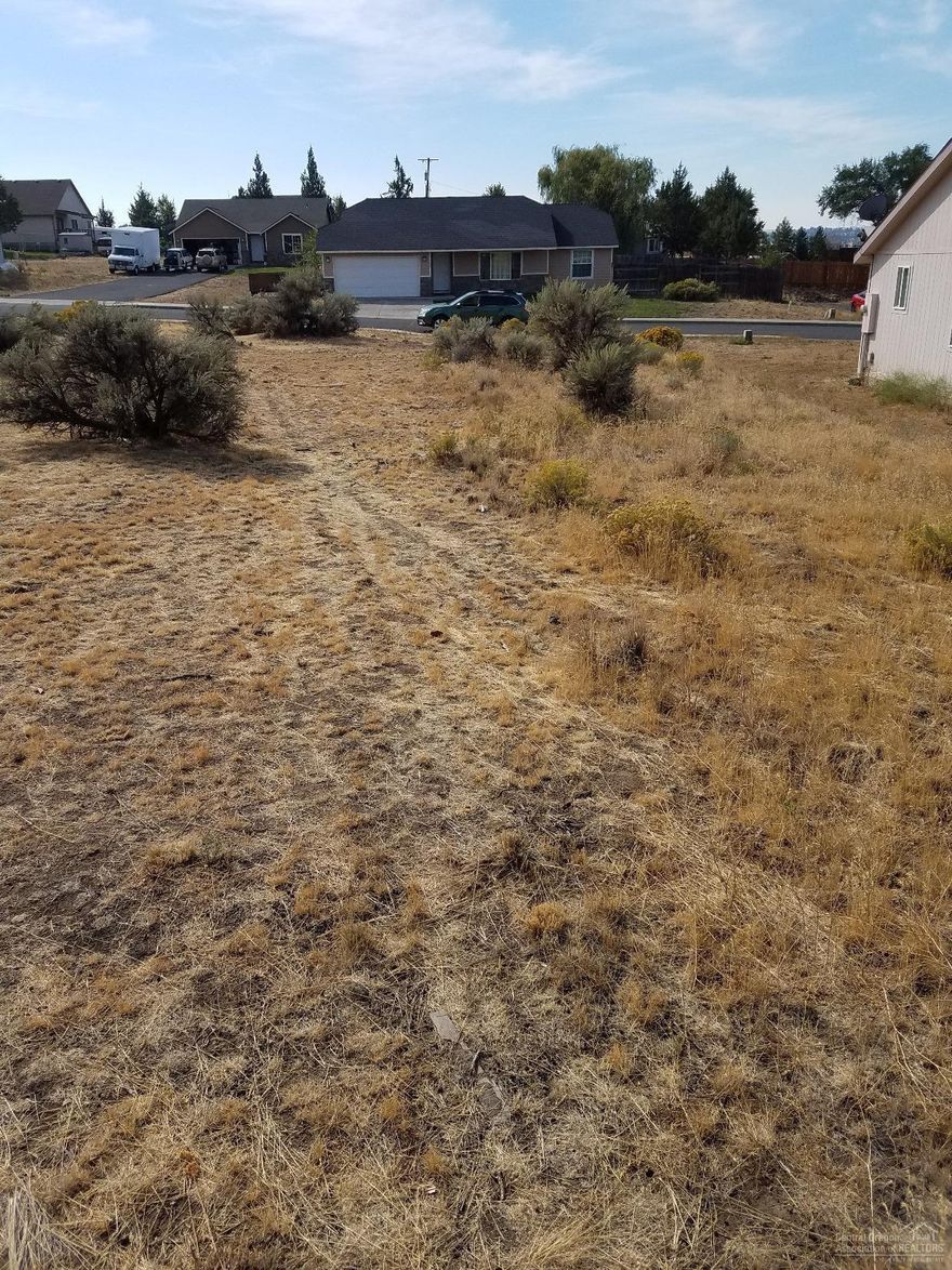 1/2 acre lot and flat house pad possible with typical excavation. View of 3 Sisters with a one level home.Bean Park across the street from the back side of the lot. Few CC&R's and no HOA. Manufactured homes allowed.
