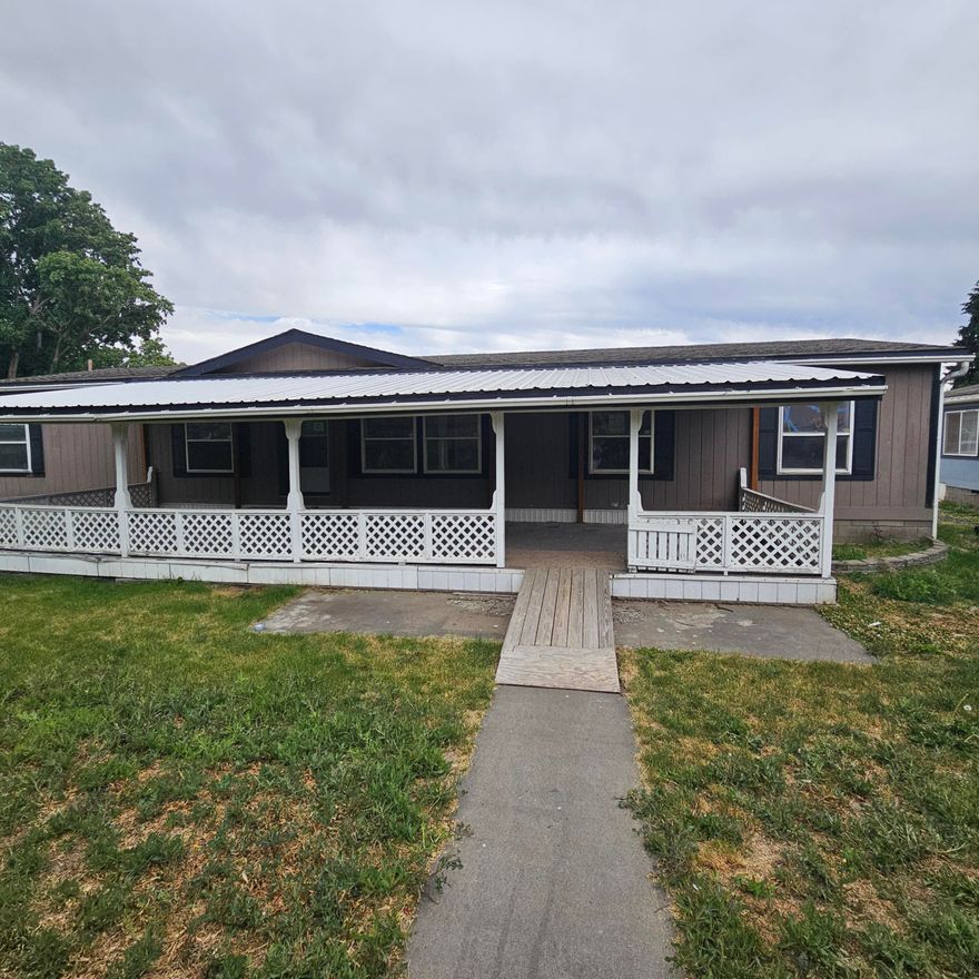 4 bedroom manufactured home is being sold ''as-is'' and needs intensive TLC. Located in town and offering a large front porch; and spacious living areas. This home has potential but requires  more than cosmetic updates, appliances, window repairs and furnace are needed. There may also be possible plumbing repairs. This is a great investment opportunity for the handy person, investor or DIY owner. Property as a residence is a legal non-conforming use; it is a residential home in a commercial zone. Buyer to verify with County what limitations if any this may create for their intended use. This property is a Foreclosure and is being offered as-is.