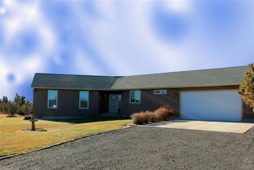 10 Private acres. Immaculate 1818sf custom ranch style 3bd/2ba home with attached 2 car garage. Huge 36x48 shop w/220amp & heated. Home shows true pride of ownership in the details. Beautiful tile flooring, expansive open floor plan & high ceilings. Heat pump, a/c & efficient hybrid water heater system. Landscaped w/ sprinklers, 2 Wells & gated entry. Paved road to property. Just minutes to downtown shopping