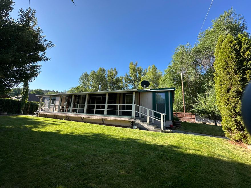 Enjoy the sound of Canyon Creek as you sit on your large covered deck. Nice fenced yard, landscaped, shallow well for watering, lots of privacy with all the foliage. Home offers 3 bedrooms, 2 bathrooms, mud room, family room & living room, attached 2 car garage, carport, lean to. Large kitchen with island, lots of counterspace and tons of cabinets. Primary Bedroom has walk in closet and primary bathroom. Home has 3 heat sources, Blazeking woodstove, oil monitor heater and electric furnace. Located within minutes of downtown John Day. Home requires flood insurance.