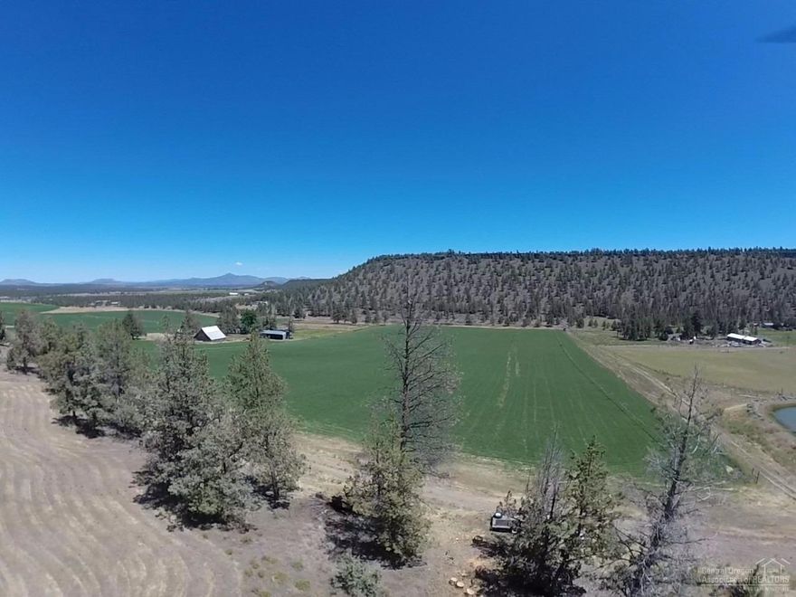 Country setting with a nice building site up on the hill over looking the field and the valley. Seasonally there are deer and elk and pond on the property. Large shop and well with gravity fed pump for the irrigation and wheel line on the property.