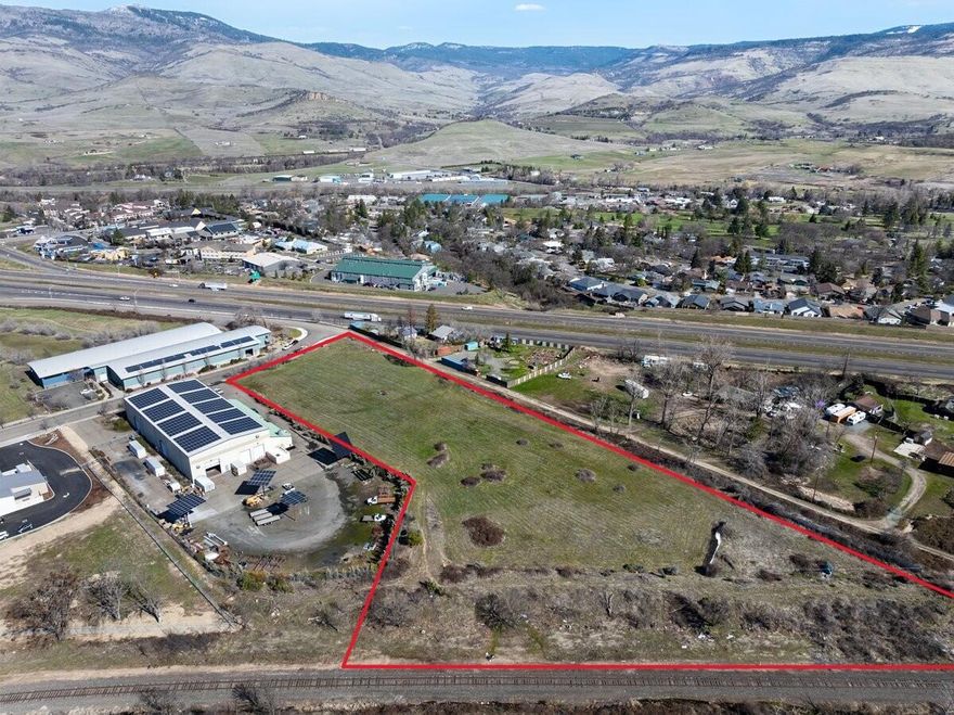 Prime 3.57-acre commercial lot in a highly visible and easily accessible location near the South Interstate 5 Ashland exit. Zoned E-1 Commercial, this versatile property allows for a variety of business/ development applications, including retail, light manufacturing, distribution/warehouse operations, and institutional or community uses. Situated in a growing business corridor with established companies nearby, this lot offers an excellent opportunity for entrepreneurs, developers, and investors looking to establish or expand their operations in Ashland's economy. Proximity to major transportation routes, enhances logistical convenience, including possible rail spur development (see docs, estimate only) making it a strategic choice for businesses seeking regional connectivity. Also potential to subdivide/Partition! Buyer to do due diligence with the City of Ashland see code 18.2.2.030 regarding intended uses.  Very favorable seller financing terns available. Contact for detail