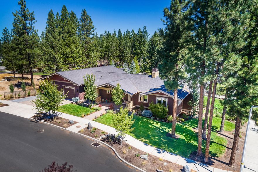 Gracious and inviting, this single level Shevlin Ridge custom home combines innovative design and carefully chosen finishes to create just the right mix of light and warmth, luxury and efficiency. Skillfully brought to life by Leader Builders, the home centers on a captivating great room with vaulted ceilings, exposed wood beams, floor to ceiling fireplace & abundant windows. Your inner chef will revel in an oversize island, custom cabinets, walk-in pantry & 6 burner range.  Masterfully designed guest/kids' wing provides privacy & separation with vaulted bonus room, 2 beds, full bath, sep. climate control.  Primary bedroom, with adjacent home office, offers vaulted ceilings, hardwood floors, generous bath with separate vanities, dual headed shower, soaking tub & radiant floor heat. Ultimate garage features extra tall doors & overhead storage, gear nook & loft space. Set on a corner lot, shielded back patio & fenced yard allow private outdoor living in an unrivaled setting & location.