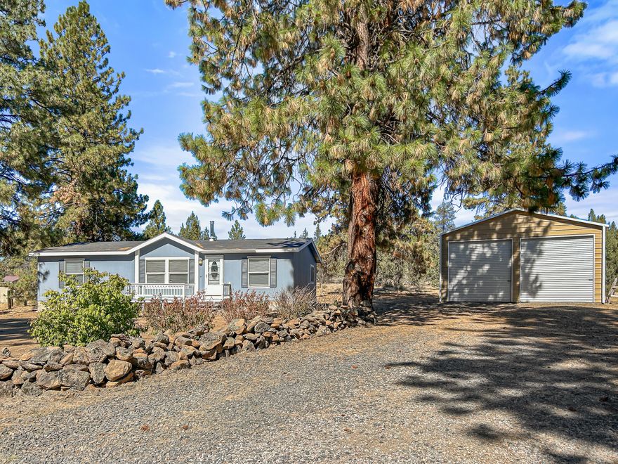 Acreage, Comfort & Country Charm! Set on 2.31 acres of flat, fully-usable land, this clean, move-in ready 3-bed, 2-bath home (built in 2008) offers the perfect blend of open space and modern comfort. Inside, you'll love the vaulted ceilings, cozy fireplace, and a split-bedroom floor plan that gives everyone their own sense of privacy. The primary suite is a true retreat with a walk-in closet and a luxurious soaker tub for those quiet, end-of-day moments. Outside, there's room for everything you dream of—gardens, animals, RVs, or just wide-open play—plus a large shop ready for hobbies, storage, or serious projects. Whether you're starting a new chapter or seeking the peace of country living with all the modern touches, this property delivers the rare combination of space, beauty, and move-in convenience.