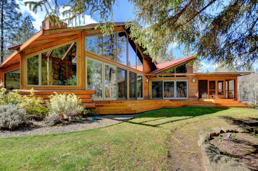 Beautiful waterfront estate on the world famous scenic & wild Rogue River, a fishing paradise. A custom designed home by Barry Gittleson of Los Angeles features recycled old growth vertical grain flooring, entry & fireplace made of stone/river rock, & soaring walls of glass by Pella bring the outside beauty in. No feature has been overlooked on this magazine cover quality home. Private, very rare location on one of the best, easy access sections of the mighty Rogue. Second living quarters adorns the property. In addition to the attached garage, there is a massive metal shop with finished interior & 3 roll up doors. Old river irrigation rights provide for the 8 foot fenced irrigated gardens & orchards. Inside is impeccable craftsmanship. Custom cabinetry, stained glass doors (Judson Studios, Los Angeles), jetted tub, slate tile, radiant floor heat in master, central vacuum, alarm system, solar water heating & large screened front porch facing the river are just a few of the amenities.