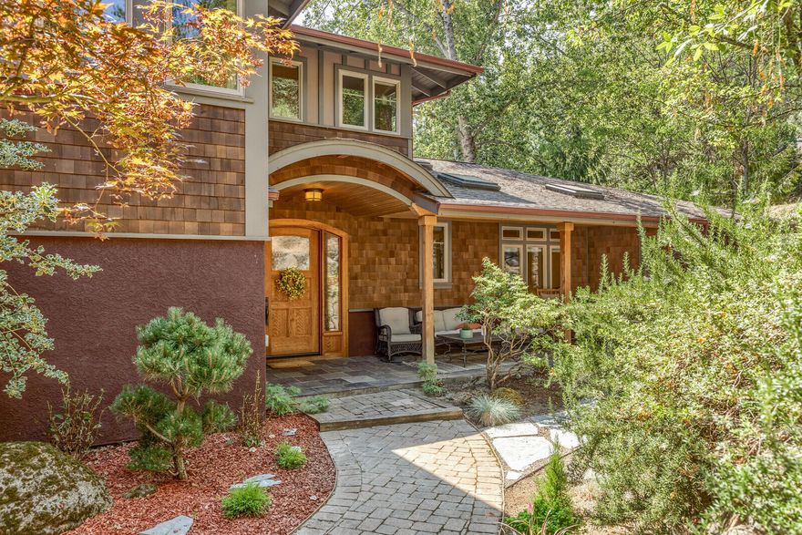 The Perfect Ashland Escape!  This stunning home offers a half-acre of peace, privacy & beauty.  Architecturally designed and custom built in one of Ashland's most sought-after locations, just 2-blocks above Lithia Park.  Custom features throughout include plaster interior walls, lofty ceilings, beams, floor to ceiling stone/tile wood-burning fireplace, professional kitchen w/top of the line appliances, wood floors, expansive view windows, pantry, laundry room and guest bath.  Main level primary suite w/glass block shower, jetted tub & large walk-in-closet.  Second level features two additional bedrooms, full bath w/ steam shower and an open loft- office.  Exterior features include a huge deck, mature landscaping, covered front porch & full attached 2-car garage.  

 Hidden private secure cellar.  This home has it all!