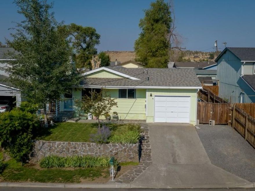 This wonderful home is cozy, solidly built with 3 bd, 2 full bath home with generous master suite, and an excellent floor plan and open feeling. New exterior sealed paint, includes dryer and new washer included, new storm door, new wood stove chimney, roof upgrade around chimney, new gutters, new bathroom vanity, new interior paint. Large, beautiful yard with fully rebuilt terraced front yard wall. Flowers, trees (Quaking Aspen for shade), lawn, gravel, water fountain. New gravel in portion of back yard with heavy landscape fabric beneath. Peach tree, blackberry bush, and strawberries. An amazing oasis all enclosed with privacy fencing! Nice back patio area could readily be converted into an outdoor kitchen. This Lovely home has it all!!! Close to Sahalee Park, Saturday Market, Performing Arts Center, Aquatic Center, Walking Trails, and only ten minutes to Lake Billy Chinook and/or Lake Simtustus. Small town living! Must see!