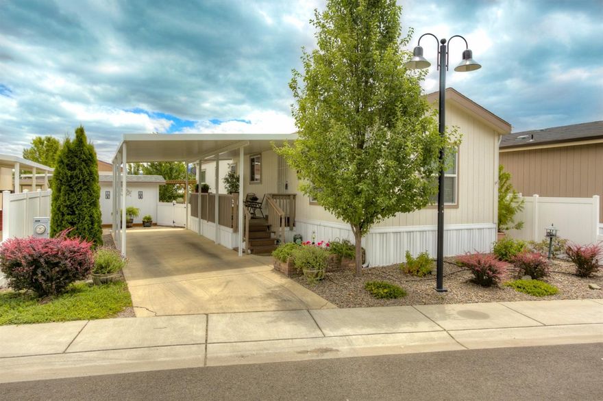 An adorable, cozy home in Cobblestone Village 55 and over park. It is a 2012 built 2 bedroom 1 bath home with a light and bright floor plan. The home and yard have been beautifully updated. The home has all new interior paint, upgraded cabinets, upgraded appliance package (all appliances including refrigerator and washer/dryer stay,) and newly redone, low maintenance yard. The park maintains the beautifully lanscaped front yard and the backyard includes mature shade trees, new side deck and new back deck with pergola. There is a newly installed dripper system for the garden boxes and a small shop that has electrical on the side yard. It is move-in ready!