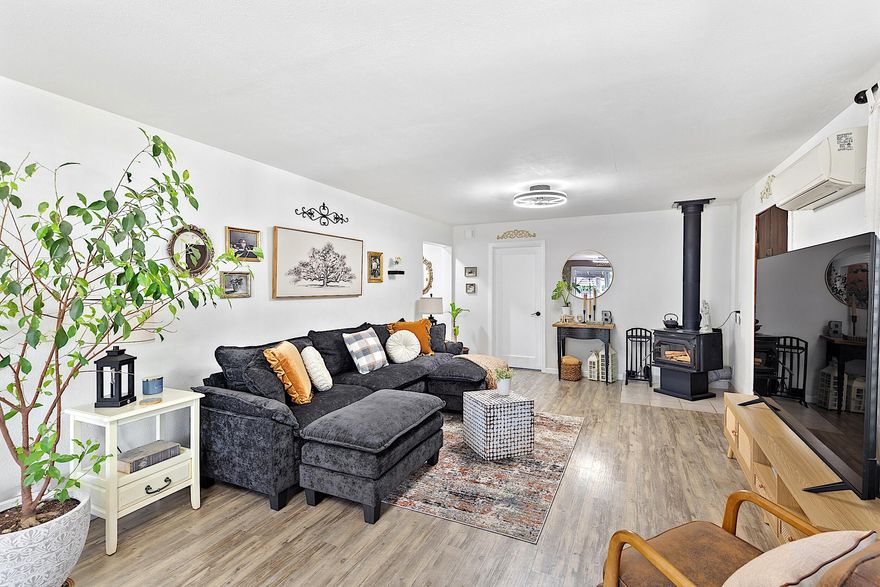 Welcome to your own private mini farm on 4+ fully usable acres, blending modern comforts with country charm. This gated, fully fenced and cross-fenced property is ready for animals, farming, or simply enjoying the land, complete with mature fruit and nut trees, garden, two wells, and irrigation. The meticulously updated home features new electrical, plumbing, roof, split systems, and expanded beautiful living areas including new flooring, lighting, amazing finishes, and an additional primary suite with it's own sitting area and kitchenette/laundry room. Outdoors, relax on the covered porches while soaking in the panoramic views. A detached garage with bonus room and laundry, 4-car carport, RV cover with full hookups, and a spacious barn/workshop offer endless versatility. This unique property is perfect for agriculture, hobbies and multi-family living and offers even more room to grow — all just minutes from Grants Pass and Medford. Don't miss out on this incredible property!