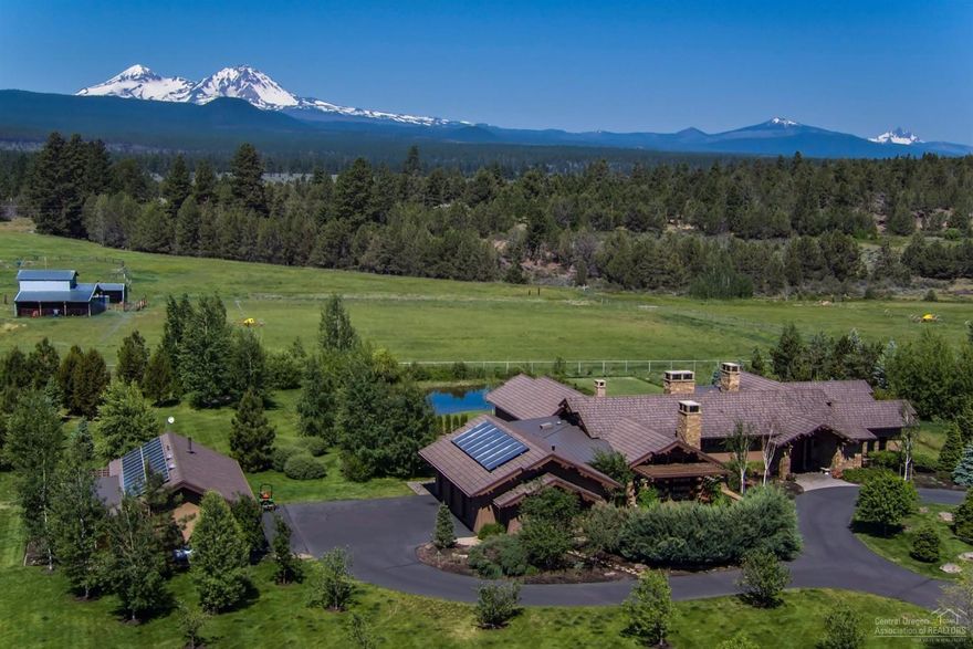 Cascade Mountain Views from the elegant estate situated in the middle of 11 acres in Tumalo. The NW Style Home features: 5614 sf with 4 bedrooms, 4.5 baths, gourmet kitchen, formal dining, living room w/ fireplace, family room, office, hot tub, single level and 5 car garage with office. Wonderful outdoor living with patios, water features, fireplace, outdoor kitchen, garden, greenhouse, orchard, barn and pond. Minutes from the Tumalo Reservoir and National Forest for any recreational lifestyle!