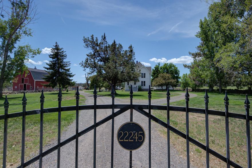 Rare opportunity to enjoy the rural lifestyle just minutes from downtown Bend on 27.89 acres served by 26 acres of COID irrigation senior water rights.   Charming farmhouse built in 1989 in a 19th Century style is updated with modern features such as central A/C and central vacuum.   Fresh white paint throughout give a country chic look with wide moulding, 9-ft ceilings & pastoral views from bright, tall windows. On main level, stained glass front door leads to living room, DR, den, full bath, large eat-in kitchen, butler's pantry & mudroom. 3 BRs on 2nd floor incl master suite with walk-in closet & laundry chute; balcony & sitting room in north BR.  Huge finished basement/man cave/playroom features wood laminate floor, laundry room, storage rooms. Oak floors throughout home, deco tile floors kitchen & baths.  Detached garage has addit. covered pkg, 2nd story 3-room office suite with full bath.  Classic red 3-stall barn with 2nd story hay/storage area. Covered gazebo for entertaining.