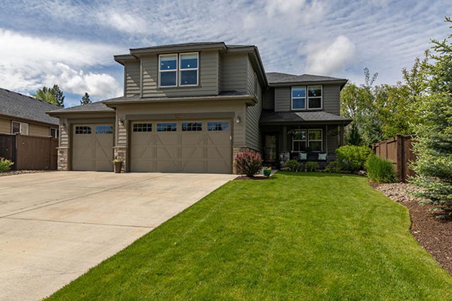 This meticulously cared for home in SW Bend is back on the market at no fault of the sellers. A charming front entry with a porch swing greets you as you enter. Downstairs you will find a great room with beautiful hardwood floors and a gas fireplace. The spacious kitchen is equipped with an island, dark stained cabinets with soft close drawers, and granite countertops. The first floor also includes a full bath, and one bedroom that could also make a great office space. Upstairs are two more additional bedrooms and a large primary suite. The primary bath features dual sinks, a soaking tub and a separate shower. A large bonus room, spacious laundry room, and another full bath complete the upstairs space. This home has a large 3 car garage and a private backyard with apple trees, a pear tree and blueberry bushes and raised garden boxes. It also has a paver stone fire pit and a covered patio with both a gas line BBQ hookup and a hot tub hookup, perfect for sitting back and enjoying it all!