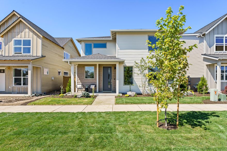 Thoughtfully designed and Earth Advantage certified, this 2,353 sqft home offers a perfect blend of style and function. The open-concept main level features a gourmet kitchen with Kitchen Aid appliances, solid slab counters, and a custom metal stair railing that adds architectural flair. Enjoy cozy evenings by the gas fireplace with a strained beam mantel or entertain on the covered rear patio overlooking the landscaped backyard. Upstairs, you'll find a spacious loft, three bedrooms including a luxurious primary suite with a large tile shower and frameless glass enclosure, and a well-appointed laundry room with sink and cabinetry. With 2.5 baths, a 2-car garage, and high-end finishes throughout, this home checks all the boxes.