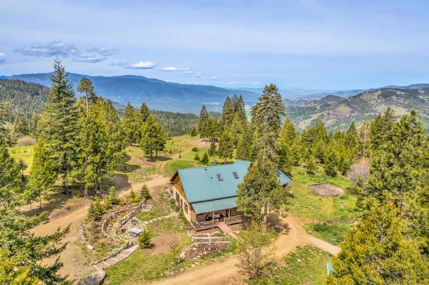 Exceptionally rare compound or retreat property with two custom homes on 166+ private acres bordered by BLM land in the Cascade-Siskiyou National Monument; less than 20 miles from downtown Ashland! Multiple outbuildings, greenhouses, loft barn with studio apartment and workshop, pole barn, 17 acres of fenced area, mature timber, seasonal creeks, ponds, waterfall, irrigation rights, and private spring. Perched on the rim of the Greensprings above the fog, the property enjoys cooler and cleaner air than town, sunset views to the Western mountains, and brilliantly clear starlit nights. Main home by reputable local contractor Mark Lackey of Integrity Building with vaulted ceilings, exposed timbers, wide-plank oak floors, and composite decks. Flagstone patio, outdoor dining area with wood-fired oven, and stone terracing. Guest home with two bedrooms, full kitchen with commercial-grade stainless range, floor-to-ceiling bookshelves, and live-edge staircase. Inquire with agents for details!
