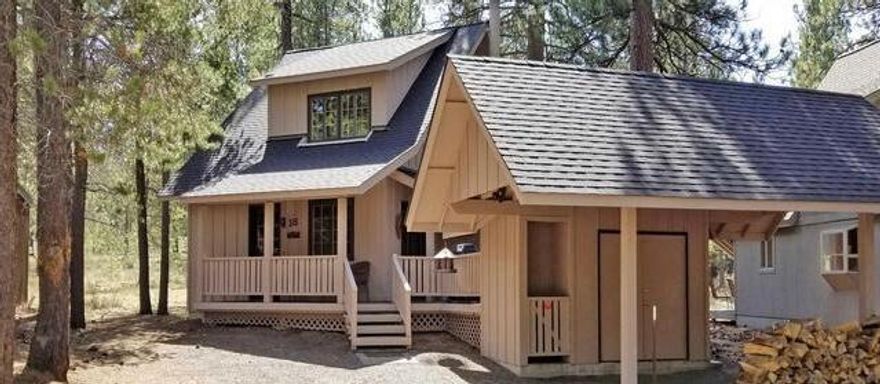 PRICE IMPROVEMENT! (Reduced $15k+)-Beautiful Sunriver style cabin located near the Village. This home features an open living concept with a wood burning fireplace, wood accents, granite breakfast bar and built in seating perfect for entertaining. The private deck is a great place to view the Central Oregon starry nights and sunny days. Many updates in this home include new granite counter tops, new carpeting/flooring throughout, new window coverings, new asphalt driveway and more! Upstairs features two bedrooms with an updated bathroom. Skylights and windows bring in all the natural light! The perfect Sunriver getaway cabin.