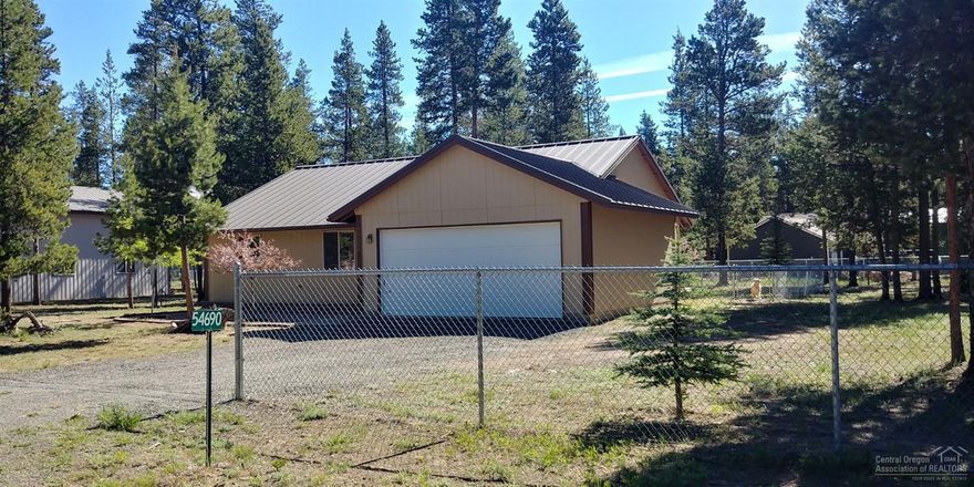 Immaculate home on corner .97 acre lot w/mature landscaping, private, fully fenced. Easy maintenance for your primary or vacation home! Gated entry. Vltd rooms w/Large windows w/great natural light. Galley kitchen w/pantry. Master w/custom, walk-in closet. Huge shop w/pulley for loft area: 1536 sqft lots of windows, 12 x10 ft RV doors. Metal roofs! Trex deck! Appliances go w/Sale. Great primary or vacation home/rental! RV access/Encl.parking!