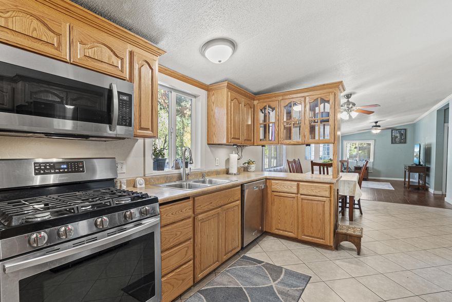 Experience the best of Applegate Valley living just a mile from scenic Applegate Lake! This charming 3-bedroom, 2-bathroom, 1,584 sq ft home features an open split floor plan, vaulted ceilings, and modern stainless steel appliances. The fully fenced and cross-fenced yard is ideal for pets and livestock, complete with a chicken coop and a spacious animal shelter. A detached garage includes a bonus room and workshop, perfect for hobbies or extra storage. Located in a peaceful cul-de-sac, this home is a true sanctuary for outdoor enthusiasts and nature lovers alike!