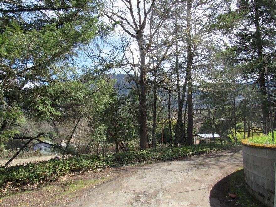 Check out this semi private treed setting for your future home- live in the older Mobile home or build on this .91 acre lot, in the UGB, close to town, peek a boo view property - Easement access. Well and septic on property. Mobilehome is 2 Bedroom, 2 BA with some updates over the years. Needs some TLC. Grounds are charming for a nice build site. Buyer(s) to do their due diligence, check with city planning regarding any improvement requirements, future access/ availability to city water, sewer, utilities, fees, and future uses or restrictions. Mostly level, GPID irrigation ditch runs around part of the property allowing for sprinkler watering during summer months.Grab your builder-With vision, this property has potential-nice view property close to town. Check it out today.Cash only, will not finance.