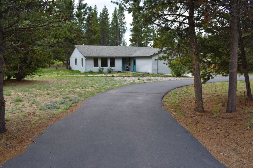 Looking for an updated, ready to move in Property? Looking for a Paved Road? This could be of great consideration!  Home sits on a fenced corner lot approx. 1 acre + or - ready for a new homeowner! This 3 bed 2 bath 1704 square foot stick built home has been updated with a new front door, new laminate flooring, new carpet in master bedroom, updated kitchen, bathrooms, new paint inside and out! The certified wood stove sits on a custom cobblestone surround and tile platform with a custom juniper mantle. cozy for cool weather. Living room has wood wrapped windows. Home is located in a nice area of La Pine, near La Pine State Recreation Park. Easy access to Sunriver and Bend. With almost an acre of land, has a nice yard, and is fenced with a paved driveway!  This one is ready to go!