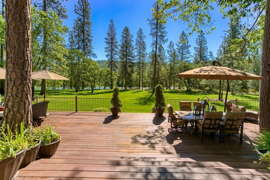 EXCEPTIONAL! This is truly one of the most stunning Rogue River front estates you will find in the Rogue Valley. A magnificent stroll past vineyards, pine trees and picture- perfect pastures soothes you as you enter this retreat property. The home is designed to take in the amazing views of the Rogue River from nearly every room. Impressive great room w/ floor to ceiling rock fireplace is open to the Chef's kitchen w/island, pantry, double ovens, built-in fridge, wine fridge, gas cook-top w/grill, & casual dining area with darling antique stove. Spacious master suite features private deck access, cozy fireplace, walk-in shower, dual vanities, large walk-in closet, heated tile floors & soaking tub. The formal dining room is spacious w/ lovely river views & the formal living room is stunning with artistic woodwork throughout. Guest wing features 2 bedrooms & a comfortable bath with walk-in shower, soaking tub & private vanities. Expansive deck overlooking the Rogue. 4300+sf shop.