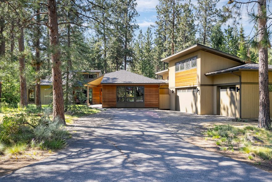 Discover a truly unique home in the highly sought-after Sunrise Village community known for its spacious lots, majestic pine trees, and unbeatable access to all of Bend's outdoor mountain adventures. Situated on a spacious .85 acre lot with private backyard, this single level Scandinavian-inspired retreat blends timeless design with natural surroundings.  The primary bedroom features vaulted ceiling and bathroom with heated tile floors and a steam shower. The great room offers a wood-burning fireplace ideal for cozy, peaceful evenings. Wood flooring flows throughout the main living areas & vaulted ceilings give the spaces a light and airy feel. Additional highlights include a three-car garage, expansive gear room, and a distinctive office space with a retro brick accent wall. Enjoy all the amenities of living in Sunrise Village with extensive walking trails, direct access to the Deschutes River, community pool, tennis court, clubhouse & more!