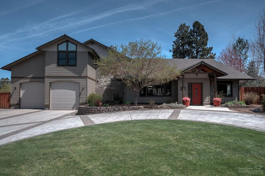 This beautiful, pristine home welcomes you as you enter from the gracious circular drive into its dramatic great room featuring stone gas FP with built-in cabinets, large kitchen, dining area & sitting room with wet bar. Entertain friends & family in the kitchen with solid surface counters, cabinets & island with bar seating. 1-level living on the main floor with 2BRs incl the master suite with luxury walk-in closet & bath, addit 1.5 baths, large laundry room & great room. Step through French doors onto the patio with hot tub surrounded by perennial beds, lawn & graveled RV area in the fully fenced deep back yard on nearly 1/2 acre. The tandem 3 car garage/shop deep enough for boat pkg has 3 doors for entry from front to rear. Deep, wide stairs lead to the 2nd floor featuring 3 BRs, bath & huge family room.You will love living in the close-knit Camden Park neighborhood conveniently located 5 minutes from shopping in SE Bend. In-floor radiant heat throughout home. See 3D virtual tour.