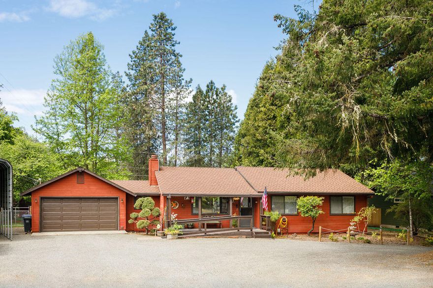Living the Oregon dream! Park-like setting with private deeded Rogue River access at the end of the cul-de-sac. Or perhaps take a stroll along the wonderful walking path that runs between Weasku Inn and Chinook Park. This country charmer is conveniently located between Rogue River and Grants Pass. Pride in ownership is evident. 3 bedrooms, 2 full baths, family room with windows on 3 sides and 4 large skylights, along with inviting gas fire for those cool Oregon fall and winter days. The living room has a wood burning fireplace to cozy up to. The dining area and kitchen are centrally located between the living and family rooms. Covered RV parking with hook-ups located next to the 2-car garage. Enjoy the completely fenced back yard and the refreshing above ground pool for those hot summer days. A smaller fenced area with raised beds is all ready for your green thumb. This perfect package is just waiting for you to move in and make your own.