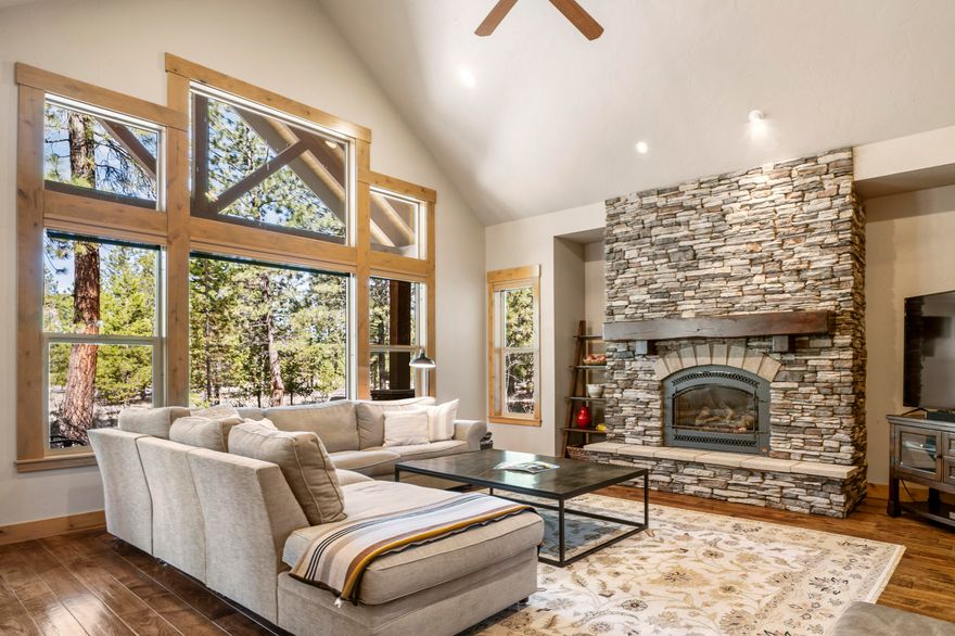 This quality-built home in Caldera Springs offers a prime location w/ easy access to all amenities. The great room features vaulted ceilings, gas fireplace & picturesque views of the surrounding woods. The beautifully designed open kitchen showcases granite counters, breakfast bar & spacious dining area. The main level hosts the primary suite, complete w/ large bathroom featuring a soaking tub, tile shower & large walk-in closet. There is a second guest suite on the main level. Upstairs, you will find 2 additional bedrooms that share a bathroom, along w/ a large bonus room equipped w/ a wet bar, gas fireplace & full bathroom. The private outdoor space includes a covered paver patio & hot tub. Large laundry/mud room leads to a heated, oversized 3 car garage equipped w/ an electric vehicle charger & epoxy floors. Fiber internet installed. Very well cared for & never been rented. 1 year home warranty included! This home is sold furnished & ready to enjoy