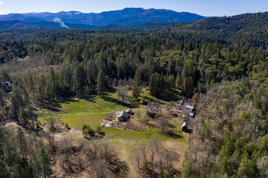 Sustainable Organic Permaculture Farm located in a Pastoral, Private Setting, almost ½ mile off Hugo Road.  The 5.64 Level, Useable Acres create a Spring Showstopper, having over 200 Fruit Trees!  Massive amount of Quality Infrastructure here, along with 5 Seasonal Ponds, & property is Fenced & Cross Fenced!  Ideal for a 2-Family Set Up, with both a 1968 Vintage Manufactured Home (1688 sf) & a 2015 Stick Built Home (1,000 sf). The Main Home is 2-3 Beds, 1 Bath, with Extra Rooms & a Hand Built ''Rocket Stove'' for heating.  Home has Newer Roof & 2 Car Garage.  The Stick Built Home is a 2 Bed, 1 Bath with Open Concept Living/Kitchen Design & German Masonry Woodstove.  The attic could be a 480 sf Bonus Room!  Outbuildings include Pole Barn, Barn, Carport/Shop, Home Office, and more.  There are 2 wells, (5 & 20 GPM per Seller) and 2-10K gal Holding Tanks.  This property is a Gem!  Please note:  Stick Built Home has no septic and no permits & several Outbuildings not permitted, so Cash Only