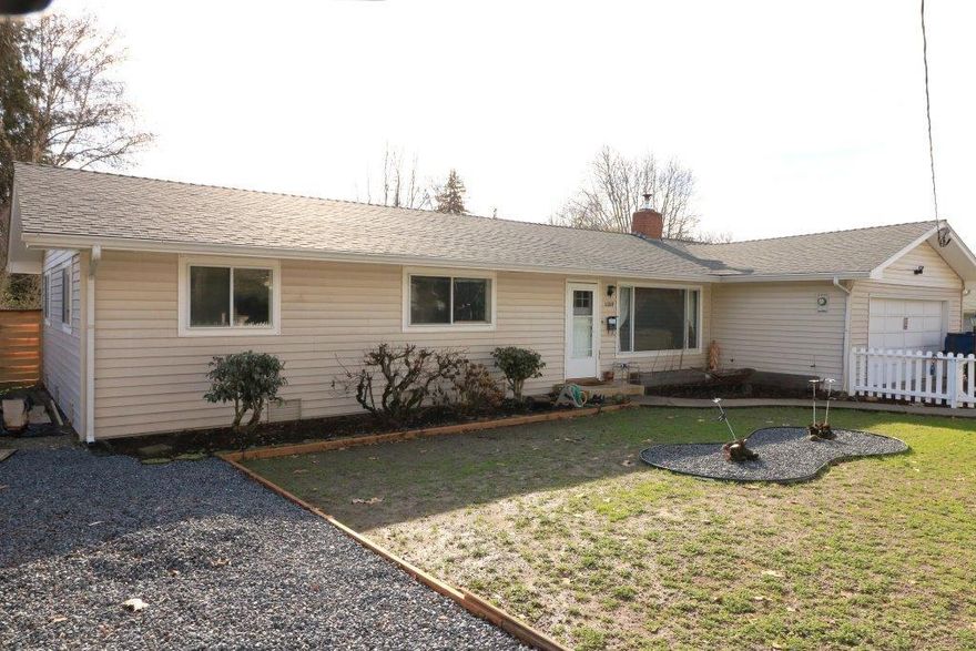 Bright and Clean! Featuring 3 bedrooms and 2 baths with beautiful original hardwood floors throughout the living room, hallway and two of the bedrooms. Comfortable floor plan with the dining room and kitchen circling back to the living room. Laundry room is off the dining area along with a second bath. A new fireplace insert keeps the whole house toasty warm! Recent updates include a newer roof, carpet less than 4 years old, and newer fencing. Summer living will be out in the large back yard! Covered patio, raised garden beds, wood shed with large enclosed garden tool closet and lawn to play and relax in. All of this on .20 acre. Close to shopping and town with city services and schools.