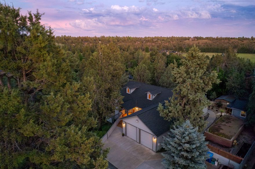 This truly one of a kind Tumalo property is a must-see! It has an enormous amount of living space. The main level has an open floor plan that is perfect for entertaining, theres an  induction stovetop & soapstone island that seamlessly blends the dining & living room, then flows out onto the deck. MAIN FLOOR; primary suite, also two additional bedrooms, & a full hall bath. Downstairs offers nearly 2,000 sq ft of finished space with a private entrance, kitchenette/bar, full bath, mud/utility room, & a flexible area for an office, gym, or guest suite, ideal for multi-generational living or rental potential. Multiple outdoor spaces, terraced landscaping, a gorgeous sunny deck, & a private hot tub. A 12' x 16' outbuilding for a garden shed, studio, or office. There's an RV 30amp hookup. With abundant storage & thoughtful design, this home is as functional as it is charming. Take a stroll to the private neighborhood access to the river trial & just around the corner from The Bite in Tumalo