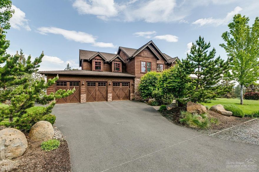 Home is where you belong & you belong here! Custom NW Farmhouse designed with timeless character & appeal. From the wraparound front porch to wainscot to beamed ceilings, the details set this home apart. Style & function converge to offer a dynamic floor plan featuring vaulted great room, main level master, den with built-ins, bonus room, and more. The island kitchen awaits your culinary skills and is equipped with farmhouse sink, premium Monogram appliances, concrete counters, and pot filler. Gather for life's most memorable meals at the built-in banquette! Quality continues with stone bathroom surfaces, clad wood windows, custom wood blinds, central air. Wooded surroundings frame Pilot Butte and easterly views. Spacious composite decking with separate hot tub hosts your outdoor events. Oversized 3-car garage includes epoxy floors and dedicated storage/shop room. Dynamic location adjacent to golf, trail access, & the best of Bend's Westside! Discover what you've been missing!