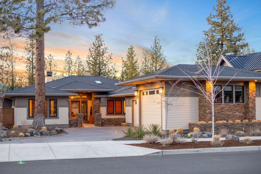 Welcome to the Modern Tree House, where timeless design + natural beauty come together seamlessly. This stunning custom home in Discovery West offers a peaceful sanctuary with floor-to-ceiling Sierra Pacific windows that flood the space with natural light and make you feel like you're living among the trees. Designed for gathering, the thoughtfully crafted kitchen features a Wolf appliance package + Cambria quartz countertops, while the seamless indoor-outdoor flow leads to a spacious patio with an outdoor kitchen, hot tub, and gas fire pit—perfect for entertaining or unwinding under the stars. The single-level layout offers luxurious comfort throughout, with heated tile floors in every bathroom. The 3-car garage includes a 28ft deep Sprinter bay with a 10-ft door, making room for all your Central Oregon adventure gear. Just minutes from trails, Northwest Crossing dining, and so much more, this home is where comfort meets luxury in one of Bend's most sought-after neighborhoods.