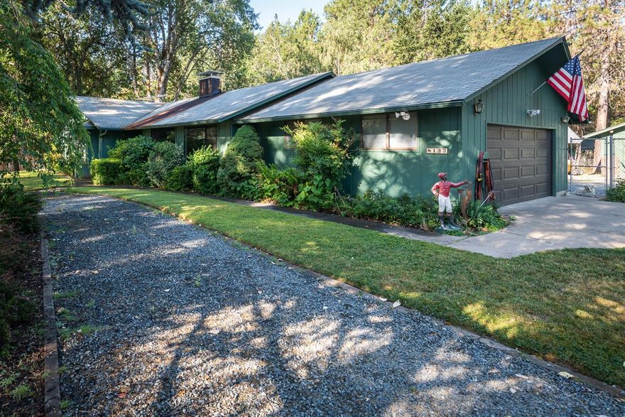 Privately set off the road on 1.35 fenced and level acres. 1688 square foot ranch style home has everything you are looking for and there is nothing to do except move in! The property has a gated entrance, circle driveway, covered RV parking, detached shop building with roll up door, Attached 2 car garage PLUS2 additional shop/storage buildings, garden, fruit trees, open space and woods. The immaculate home features a spacious living room with large picture windows and woodstove, dining room with a Beautiful brick fireplace and glass doors to the covered deck, kitchen with lots of extras including pull out drawers, lazy susan, cook top, microwave and wall oven and laundry room with pantry closet. The one level, 3 bedroom, 2 bath floor plan also includes a Master Suite with glass doors to the deck and spa. There is a two car attached garage with cabinets, separate hobby or exercise room, Hot tub on the covered porch established landscaping,13 KW Diesel Generator with a 500 gallon tank.