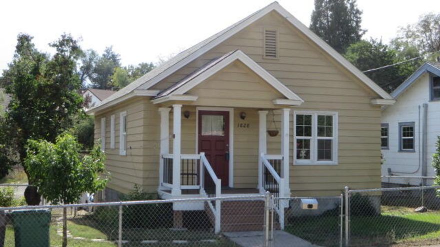 This ''sunny and sweet'' home has been renovated but still maintains its original charm. 2 bedrooms, 1 bath with 760 sq ft of living area PLUS an unfinished basement. Traditional character throughout with numerous updates: roof, vinyl windows, hot water heater, exterior paint, and updated electric service panel. Nice kitchen with an eat-in dining area, range and refrigerator. Oak hardwood floors in living room and bedrooms. Gas floor furnace that's been recently re-conditioned.  Window air-conditioner is included. Basement has above-ground windows, utility area with laundry sink, ample storage space and a single-car garage area accessed from the back of the lot. Most of the lot is perimeter fenced and has an appealing cozy back yard area for friends to gather. This home sets back from the street and is on the bus line for OIT, the Hospital, downtown, and is only minutes to Kingsley Field Air Base.