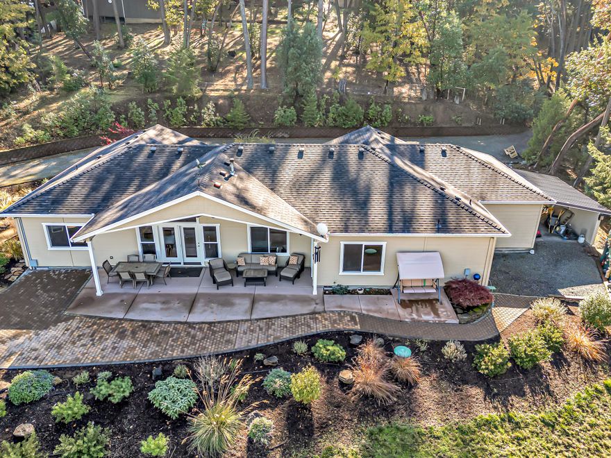 Welcome to your move-in ready retreat on just under 5 acres of private Rogue Valley land. This immaculate single-level home built in 2014 offers 3 bedrooms, 2½ baths, & a spacious 3-car, finished garage & well flow of 14gpm! The industrial hobbyist will appreciate the 30 x 40 shop, built in 2021 with 220 power, 14ft roll up door & office area. Vaulted ceilings in the great-room with a cozy pellet-stove & panoramic windows framing spectacular hill & city-light view. The kitchen shines with large island, leathered granite counters, white cabinetry, pantry & stainless appliances. The primary suite features a walk in closet, updated bath dual sinks, water closet & large soaking tub. Outside, entertain under the huge covered patio, gather around the fire-pit & take in the evening glow of the valley. There's RV parking with full hookups large enough for a big rig! Plenty of room to add a pool or additional outbuildings. Don't miss your chance to claim this home in this coveted location!