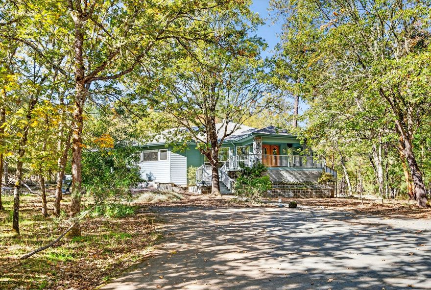 Custom home in one of Grants Pass' most premier gated communities & first time on the market. The property also backs to BLM and connects to Cathedral Hills Trails.  Situated on 3.16 acres, the home features 3537 sq ft, 3 beds, 3 full baths, beautiful open floor plan, floor to ceiling built-in book shelves, huge kitchen with island, pantry & built-in desk area.  The primary suite is a retreat all it's own, with dual vanities, jetted tub & custom sauna.  There is a second ensuite bedroom & bonus sitting room.  Exterior features include wrap around deck, covered patio with outdoor kitchen, attached 2 car garage, plus carport, huge storage or workshop area under the home & paved driveway. Enjoy the community park with lovely pond.  The home sits back from the road for ultimate serenity.