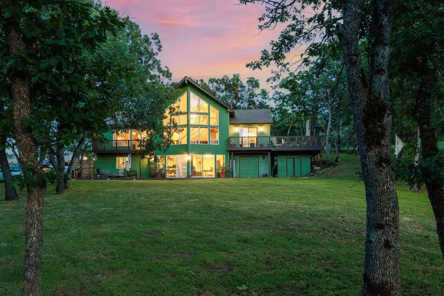 Welcome home your beautiful chalet style retreat with tree-lined hills views! Perfect location nestled between historical Jacksonville & Ashland. Live in a scenic greatly sought after location. Minutes to town, yet a quiet country setting. Access bridge to the front entry. Enjoy the floor to ceiling sunset views from your great room or loft w/cathedral ceilings. Bright kitchen w/corner windows and sink, newer appliances. Open floorplan w/breakfast bar into dining room w/sliders out to a large wrap-around deck. Great for BBQs or outdoor dining. Main floor has 2 primary bedrooms. One has a balcony, walk in closet/shoes-accessories organizer, & jacuzzi tub. Finished basement has 3rd primary bedroom, a family room & office, newer sliders,separate entry. Possible AirBnb, great for large family, in-laws, could be 2-family setup. Ceiling fans. Newer flooring, electricals and decks. Lower maintenance yard, fully fenced, timed drip/sprinklers, garden area, RV area with hook-ups. See Amen, list