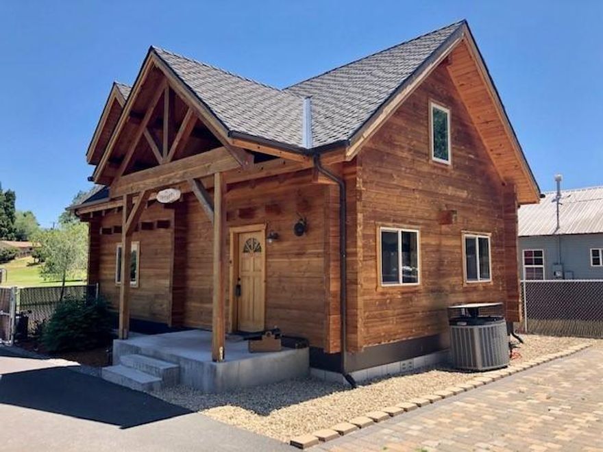 Adorable log home built in 2015, featuring slate tile floors, and laminate throughout. Carpet in the master bedroom located upstairs with a large loft area/bonus room. The kitchen is equipped with nice cabinetry, marble counters, breakfast bar, and open to the dining room. The living room is good size with a laundry closet and bathroom on the main level. Gas forced air furnace and AC, fenced perimeter and landscaped front with drip system, gated solar entry with alley access to the 28x34 shop. The shop features concrete floors, gas heat, fully insulated and finished interior with workbenches, 14' and 10' roll up doors plus 2 air compressors. Great RV parking, graveled and also accessed through the alley with separate gated entry. Beautiful park across the street and located near Harbor Isles. This is a unique property with so much to offer. Don't let this one slip away!