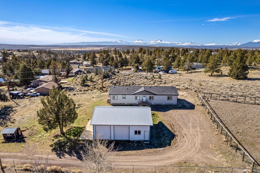 Beautifully updated home in Crooked River Ranch! The open floor plan boasts a great room with vaulted ceilings, kitchen with new stainless steel appliances, dining area, 4 bedrooms with desirable master separation, and 3 full bathrooms. Gorgeous Cascade views from several rooms of the home! All new flooring, interior paint, doors, windows, showers/tubs, new exterior paint & siding, and a new roof. Situated on over 1 acre with a 1080sqft garage/shop. Plenty of room for RV parking and toys. Across the road are trails that lead around the Deschutes River Canyon! Enjoy the many  amenities that Crooked River Ranch has to offer, including golf, tennis, pickle ball, bocci ball, a pool, parks, mulitiple hiking trails, access to BLM, and more!