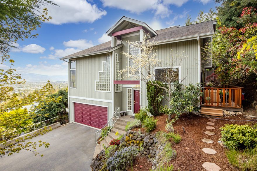 Views, Views, Views! Great natural light throughout this captivating home will please the most discriminating buyer. Architecturally stunning, the clerestory windows are perfectly placed to take advantage of the 360-degree views of the city & surrounding mountains. Cathedral vaults in the living coupled w/ the tiled gas fireplace provide glorious space for entertaining. The kitchen is a chef's dream w/ plenty of storage, granite countertops & stainless appliances. The gleaming hardwood floors are throughout the primary living areas including the stairs. You won't want to miss the balconies off the dining & owner's suite; fantastic for enjoying sunsets, morning coffee or wine. Main level bedroom & half bathroom.  Upstairs is the oversized master, private bath, walk-in closet & additional bedroom w/ huge walk-in closet. Sanctuary setting out back has privacy for the hot tub, a soothing water feature, mature landscaping & custom rock walls. 2 car attached garage w/ workshop space.