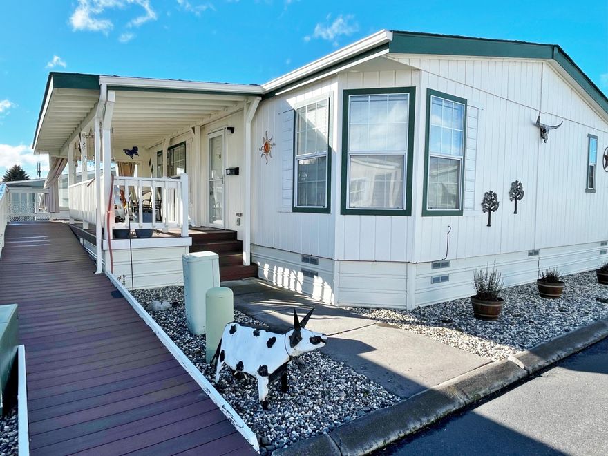 Super in Alpine Meadows 55+ Park! 1323 SQFT, 3 bedrooms 2 bathrooms in great condition with newer gas HVAC & water heater, clean paint, 2019 carpet & more. Large great room with dining kitchen combination, including all appliances, gas range & washer/dryer too. Large primary bedroom/bath and a walk-in shower in the guest bath.  Super covered deck with double handy-cap accessible ramp, fenced yard for small pet, covered carport & storage building too. Current Park rent of $402 mo includes water, sewer, garbage & snow removal & including pet park. Club House, RV storage area & RV rental spaces too for additional fee.  See Park Manager at space #1 for park approval. Easy to show so call today!