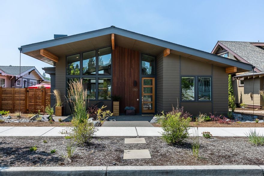 Exceptional quality throughout this stunning Mid-Century Modern home in the heart of Northwest Crossing one block from Discovery Park. This single level, Earth Advantage home built by the acclaimed 'green builder',  The Grout Company lives large with vaulted ceilings & exposed wood beams with picture windows at every angle. From the moment you step into the entry foyer, it's evident that may custom touches have been added. The contemporary kitchen is well appointed with top of the line JennAir appliances, quartz counters and drawer microwave. With hardwood floors spanning the open concept great room, foyer and kitchen, this home just flows with natural light.  Many custom features were added to include radiant heated master bathroom, upgraded lux carpet, tiled fireplace, quartz counters, epoxy garage flooring, kitchen fixtures and designer lighting. This home features a large lot with fenced backyard and two patios and lawn as well as a large front patio & eco scape landscaping.