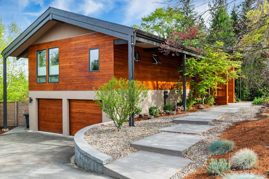 Stunning mid century modern home w/ amazing mountain & valley views! This home was completely remodeled in 2014 including new electrical, heating, city plumbing & all other mechanical systems. Home will not disappoint w/ stunning wood features inside & out. Main living area has a modern open concept w/ a wall of windows, coffered ceiling, custom lighting, wood burning fireplace w/gas, a beautiful gourmet kitchen & large deck. Primary suite has vaulted ceilings, a spa-like bathroom w/a large walk-in shower & two walk-in closets. Office/bonus room has built-in cabinetry & sleek glass doors. Downstairs you will find 2 bdrms, a luxurious bath, wet-bar & movie theater.  Exterior will capture you w/ a front yard water feature, beautiful heritage trees, heated pool, hot tub, chicken coop & TID irrigation water rights. This great location is just 3 houses away from the TID walking/mountain bike trails which leads to the Watershed (a large trail network) to Lithia Park or downtown.