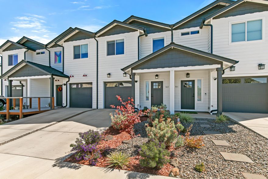 New home with modern finishes, low-maintenance landscaping, and very small association dues located within a flat half-mile of groceries, restaurants, and downtown Talent! Main level with high ceilings, wide-plank engineered hardwood floors, kitchen with leathered granite dining bar and counters, cabinets with solid wood interiors, LG appliances including electric range with convection oven, adjacent dining area and living room with sliding glass door to fully-fenced private backyard with concrete patio, powder room, under-stair storage, and one-car garage. Upper-level primary bedroom with walk-in closet and full ensuite bathroom with double granite vanity and tub shower, laundry closet with Samsung washer and dryer, two additional bedrooms with closets, and full guest bathroom with granite vanity and tub shower. Inquire for details!