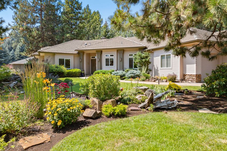 Located in Bend's highly sought-after Mountain High, this custom single-level home is a rare blend of privacy and stunning outdoor living. Set on a .43 acre corner lot with a park like setting, and the most admired gardens in the community with mature trees and vibrant blooms. Step inside to find 10' ceilings and expansive picture windows with garden views. The thoughtfully designed floor plan includes two spacious primary suites and a newly remodeled primary bath featuring high-end touches, including heated floors, towel rack, bidet toilet and a private hot tub. The beautifully updated gourmet kitchen boasts custom cabinetry and counters perfect for entertaining. Enjoy the dramatic stone gas fireplace with a light and bright open living area. Featuring a spacious 3-car garage with storage. Over $200k in recent upgrades. Includes a home warranty. Exceptional amenities include a pool, tennis and pickleball courts plus a golf course and more. Don't miss this amazing opportunity!